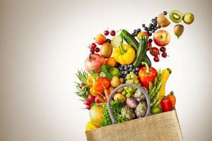 Groceries pouring out of paper bag.