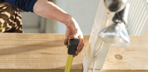 construction worker taking measurement