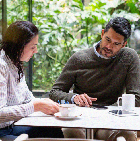 Man and woman sitting at table discussing finances