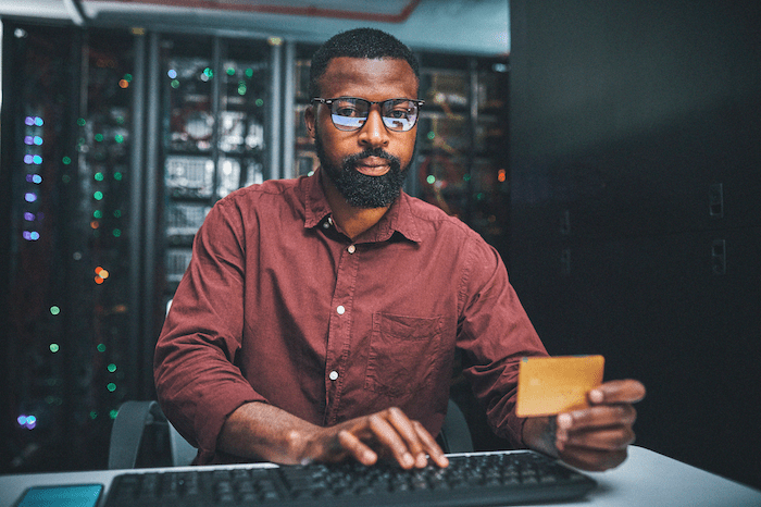 person using credit card on computer