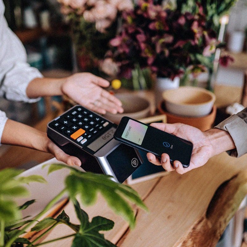 Hero image - Customer tapping phone on card reader in flower shop