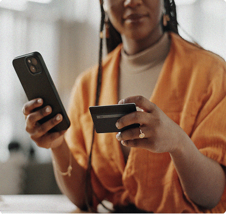 Female holding phone and credit card