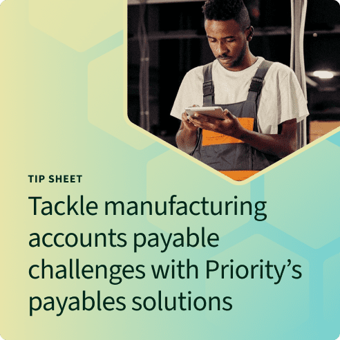 Man in a manufacturing setting typing on a tablet for payables solutions