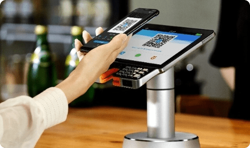 Person paying with their phone pos
