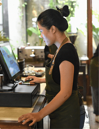 Woman standing at POS screen in a business