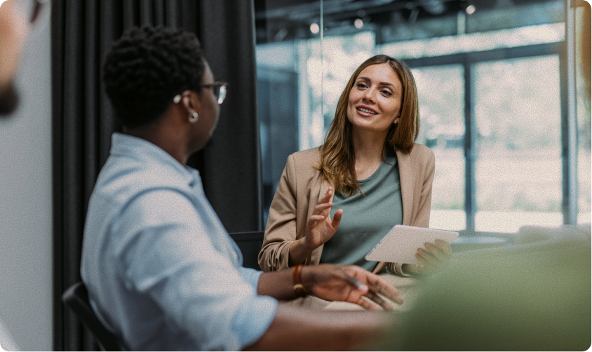 Two office workers talking at a table