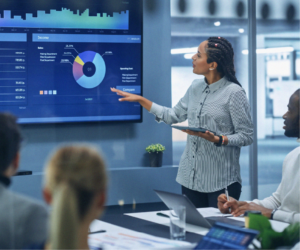 Debt resolution team reviewing CRM dashboard with analytics and workflow data