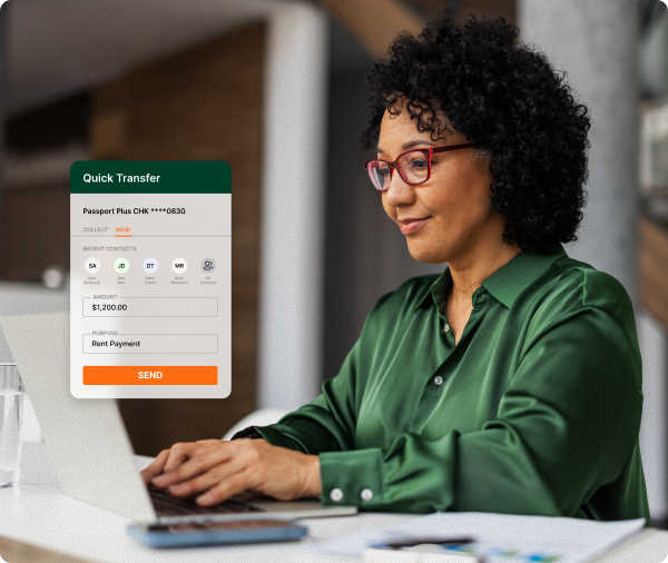 Woman at desk entering payment information into her laptop