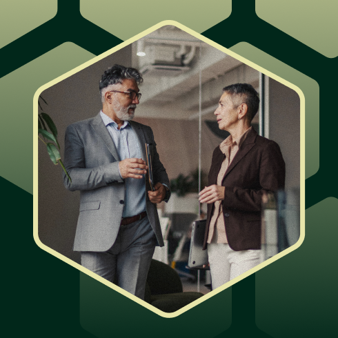 Man and woman standing in an office, talking
