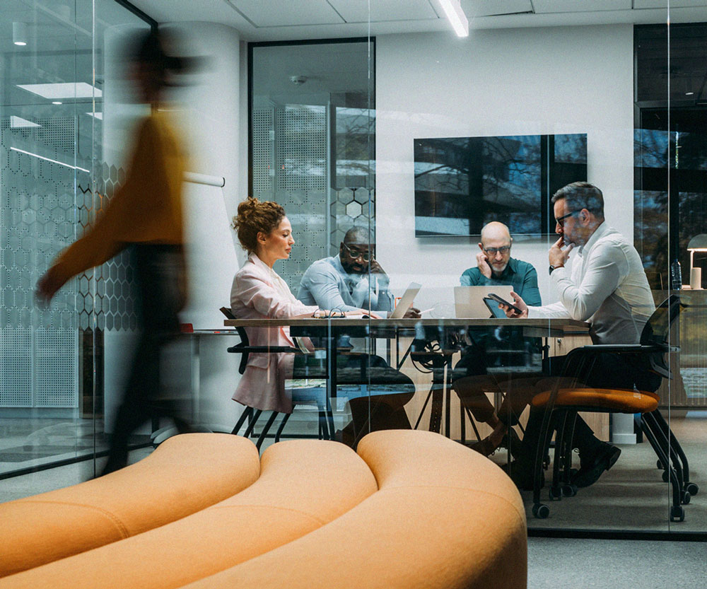 Business team discussing an integrated payment platform in a modern conference room.
