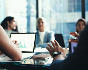 Team reviewing financial charts on a laptop during a meeting about procure-to-pay automation.